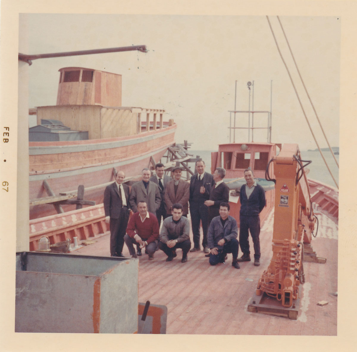 Boatbuilders and clients atop fishing trawler